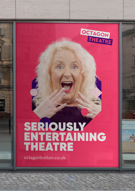 Octagon Theatre poster. An older lady with white / blonde hair looks excited and surprised. She is situated in a purple octagon on a magenta background. The Octagon Theatre logo is in the top right. The text reads: "Seriously entertaining theatre". The web address reads: "octagonbolton.co.uk".